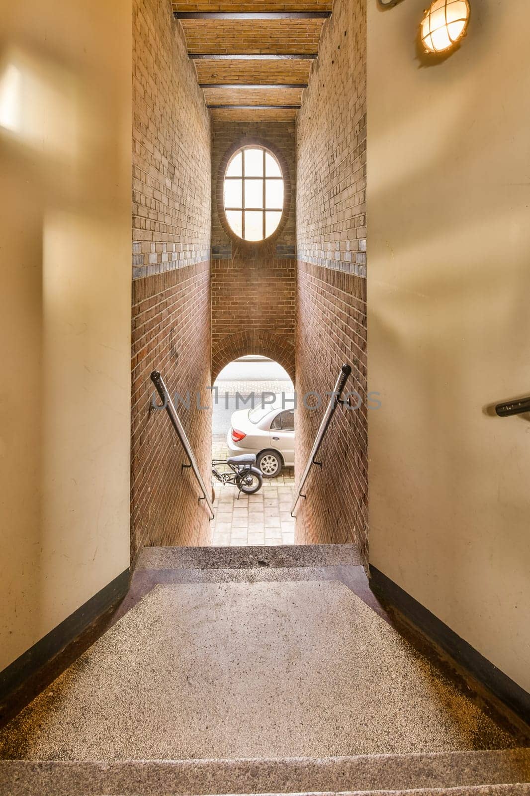 a motorcycle parked in an old brick building, taken from the inside and out with its front wheel leaning on the wall