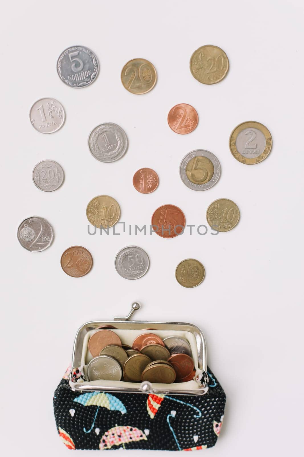 Open purse with different coins isolated on white background top view. Financial crisis, poverty, lack of money