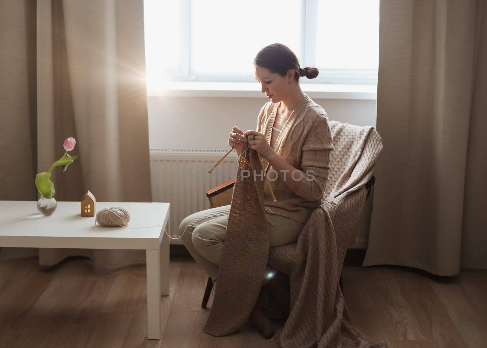 Girl knitting at home.Handmade zero waste,upcycling, small business employment opportunity concept.Hobby knitting and needlework for mental health. Cozy room interior by paralisart