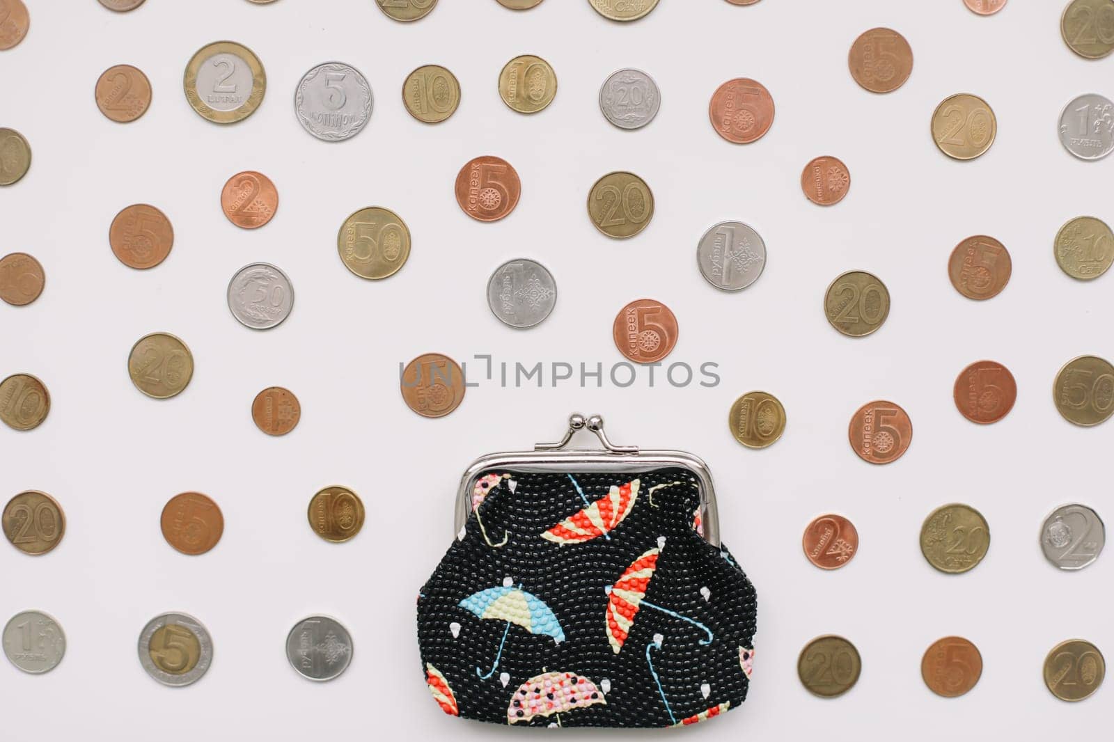 Open purse with different coins isolated on white background top view. Financial crisis, poverty, lack of money