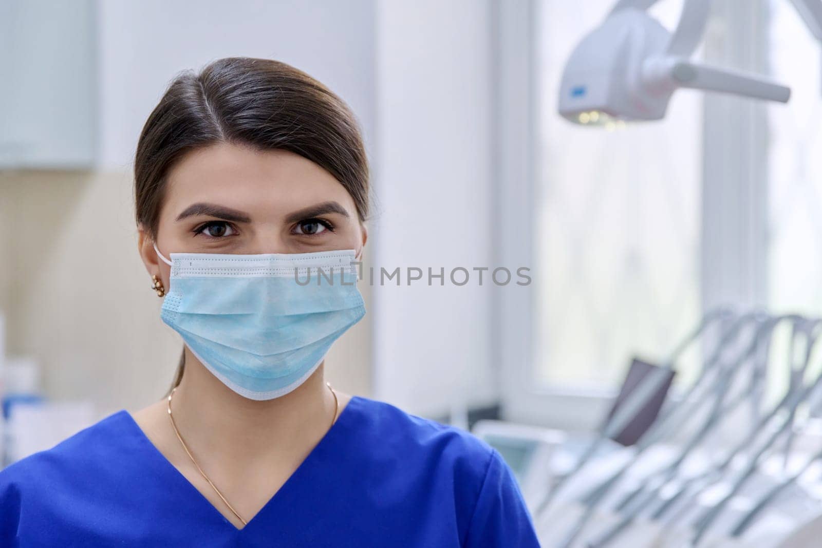Portrait of confident female dentist doctor in office looking at camera by VH-studio