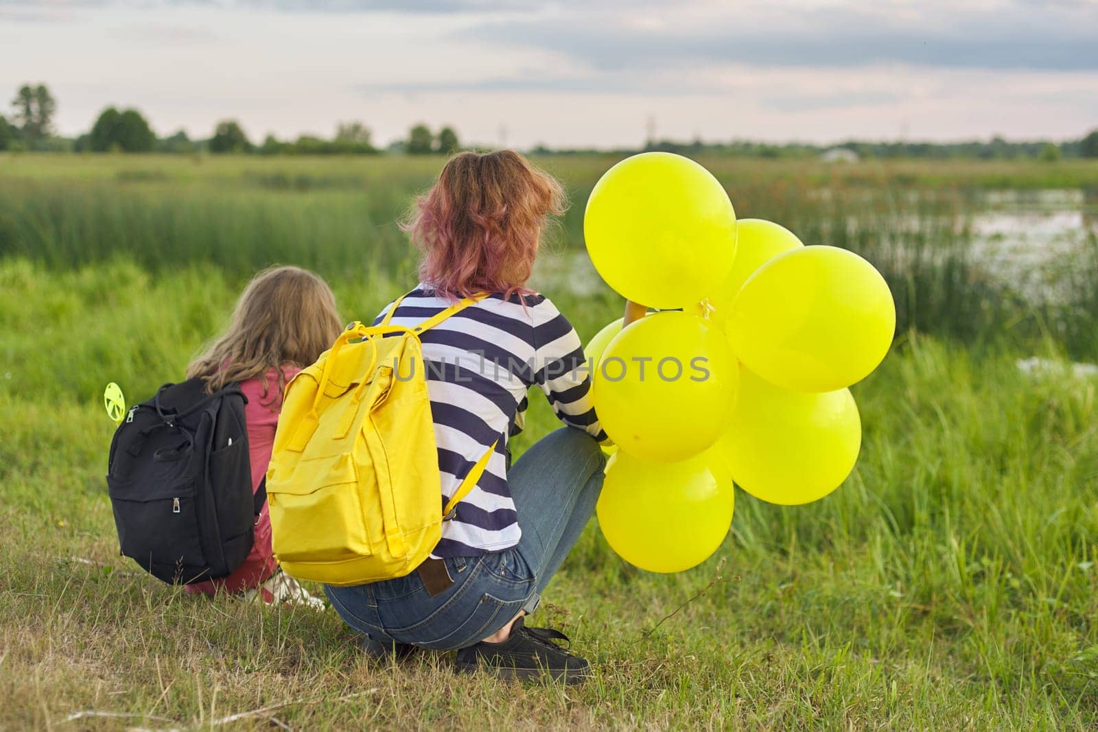 Two girls with balloons back in nature, children near the lake by VH-studio