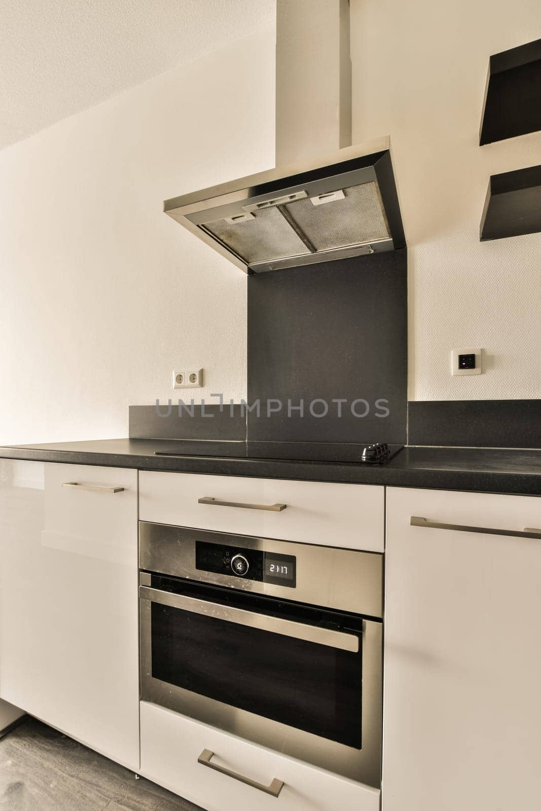 a kitchen with white cabinets and a stove and oven by casamedia