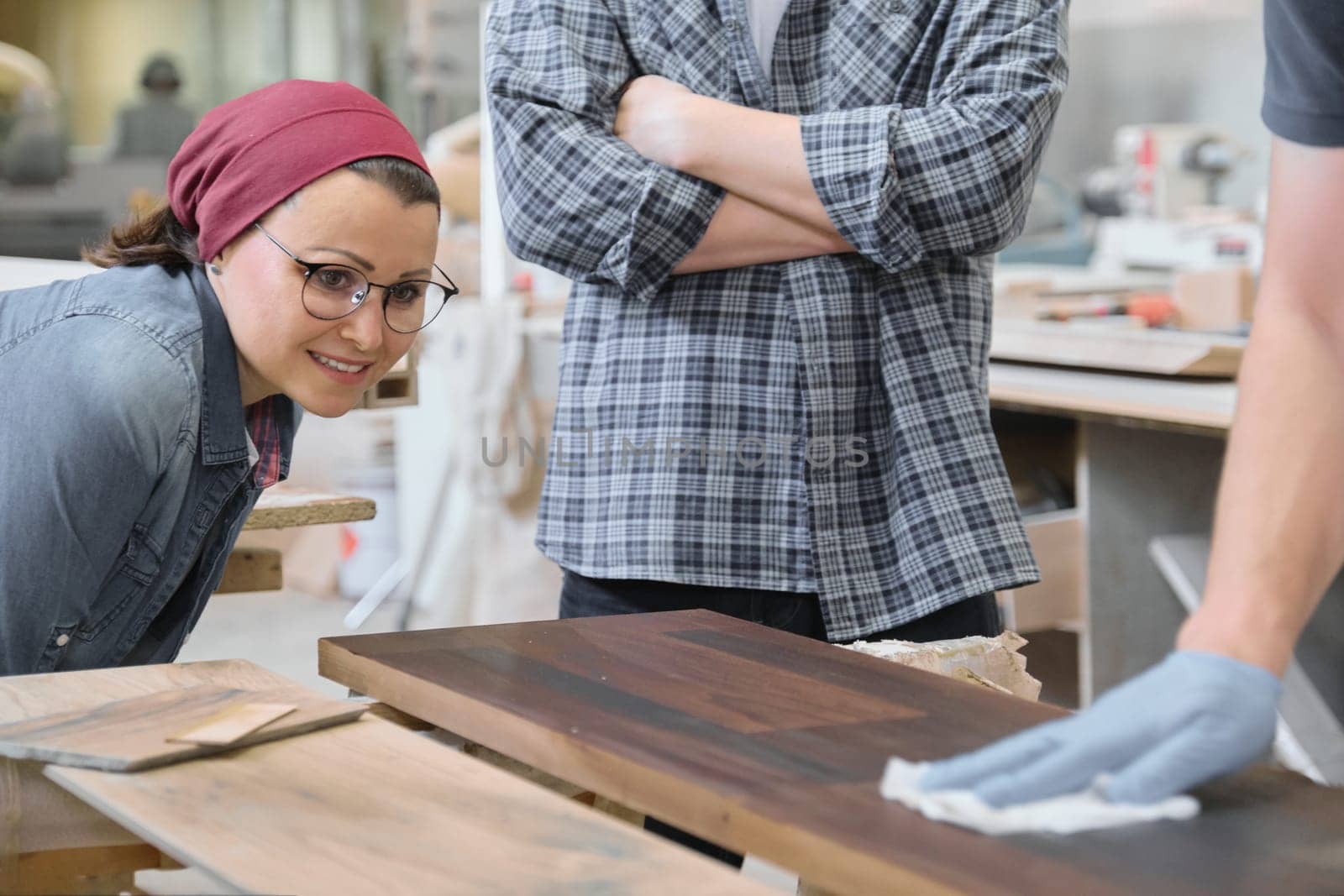 Woodworking workshop, worker varnishing wooden shelf closeup by VH-studio