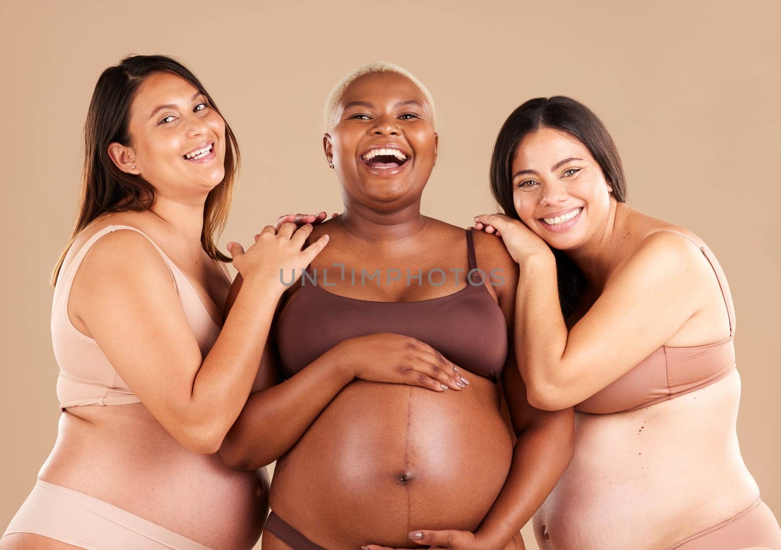 Portrait, beauty and body with pregnant friends in studio on a beige background for diversity or motherhood. Family, love and pregnancy with a woman friend group showing their baby bump stomach.