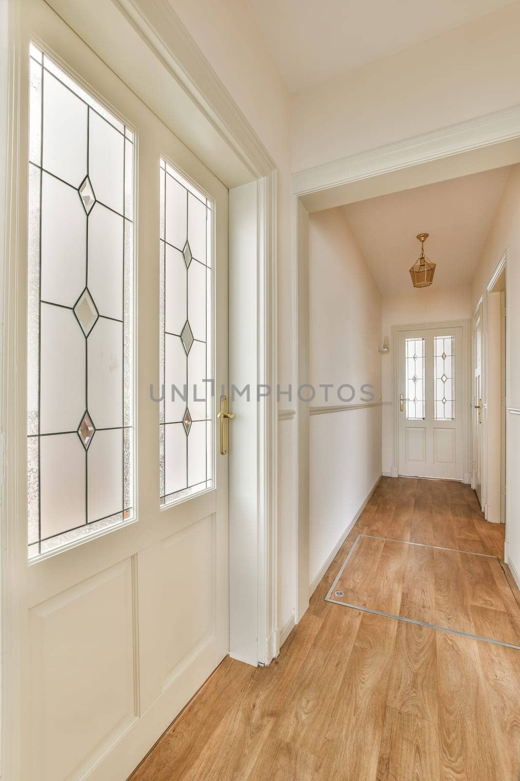 an empty house with wood floors and white trim on the doors, windows in the room is very light filled