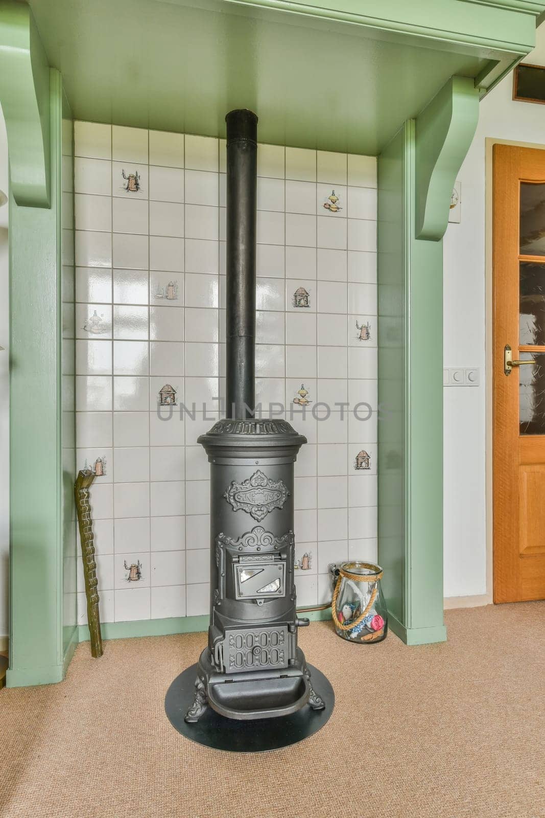 a wood burning stove in the corner of a room with white tiles on the walls and green trim around it