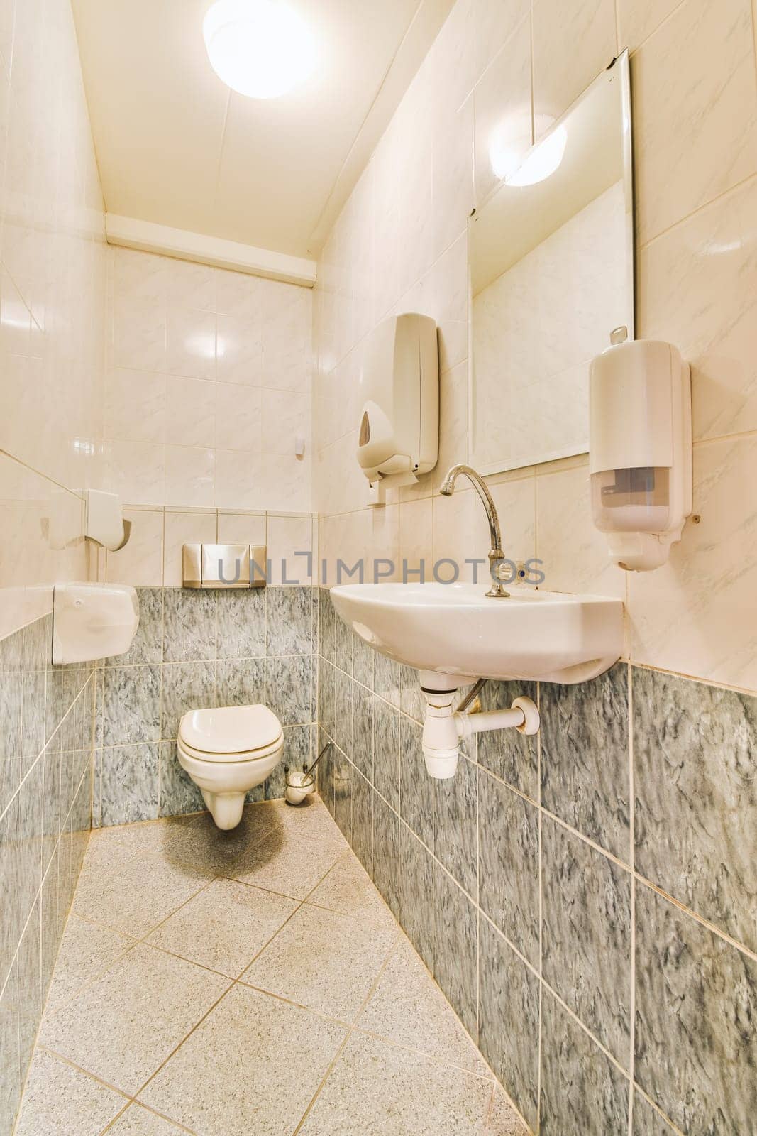 a bathroom with two sinks and one is on the wall next to the toilet in the walls are made of white marble