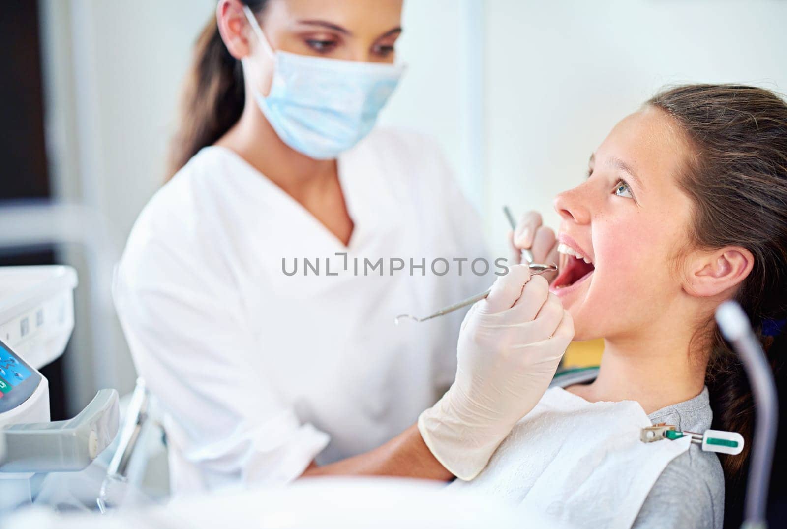 Just a quick clean. a young girl have a checkup at the dentist