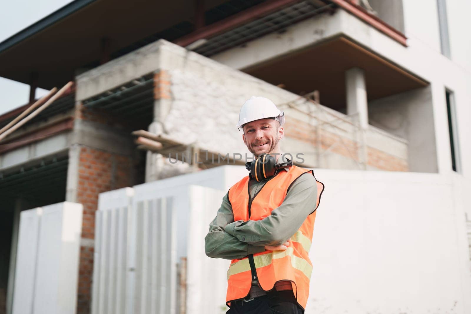 Foreman builder man at construction site. American foreman construction standing at construction site.