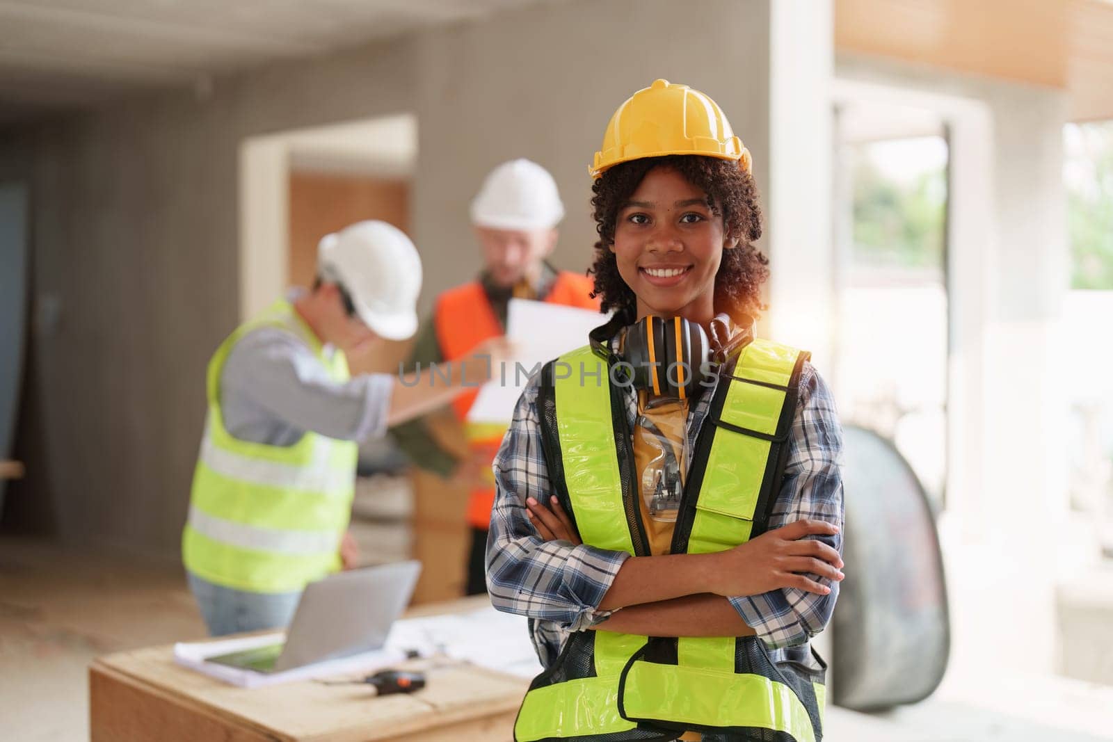 Foreman builder woman at construction site. American African foreman construction standing at construction site by itchaznong