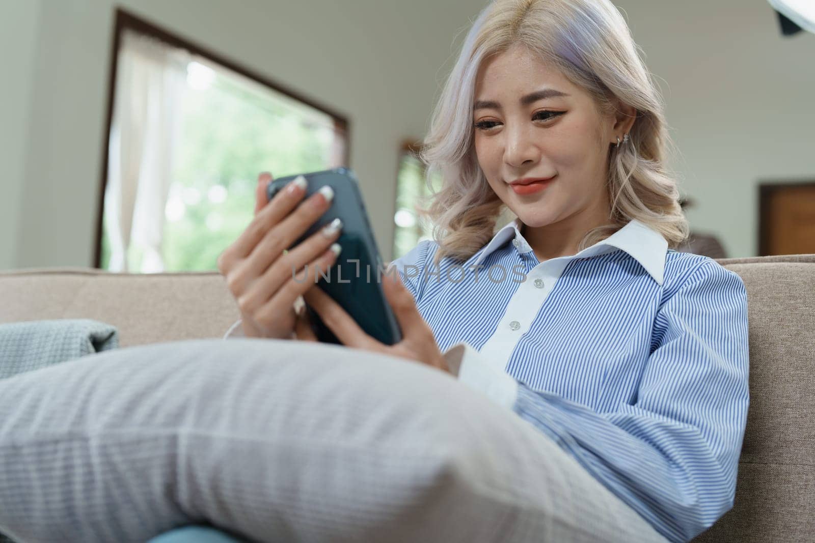 Portrait of a beautiful Asian teenage girl using a smartphone mobile.