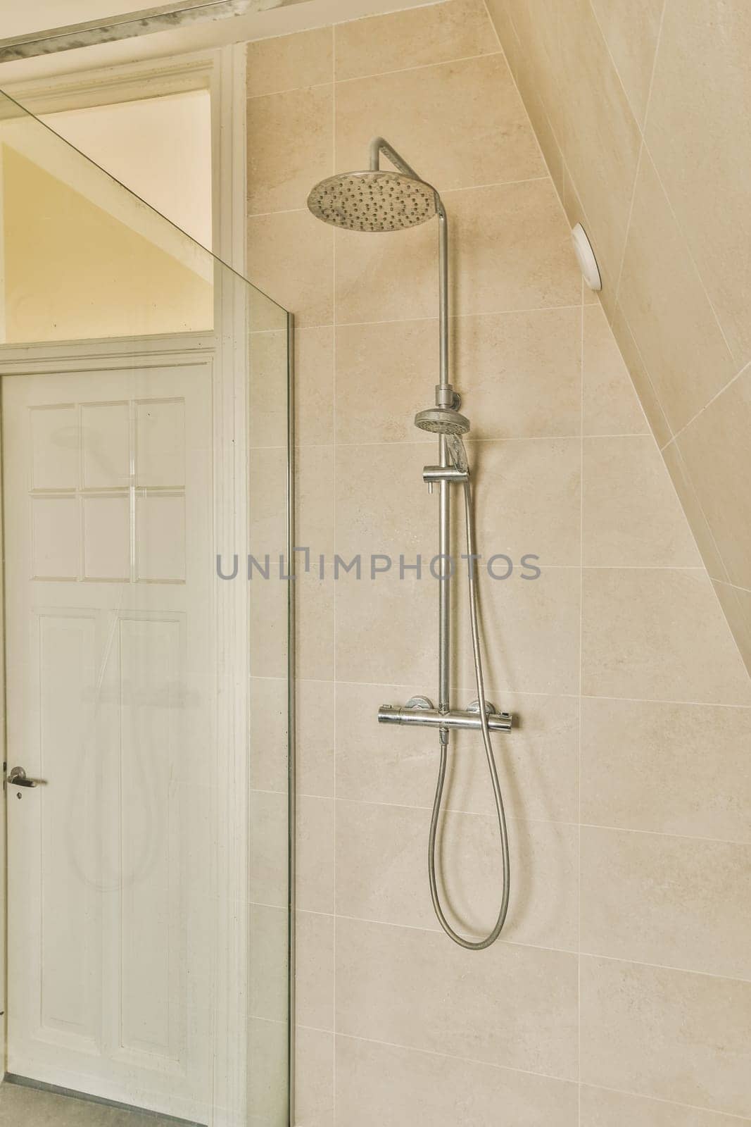 a bathroom with a shower head and hand held in front of the glass door that has been installed on the wall