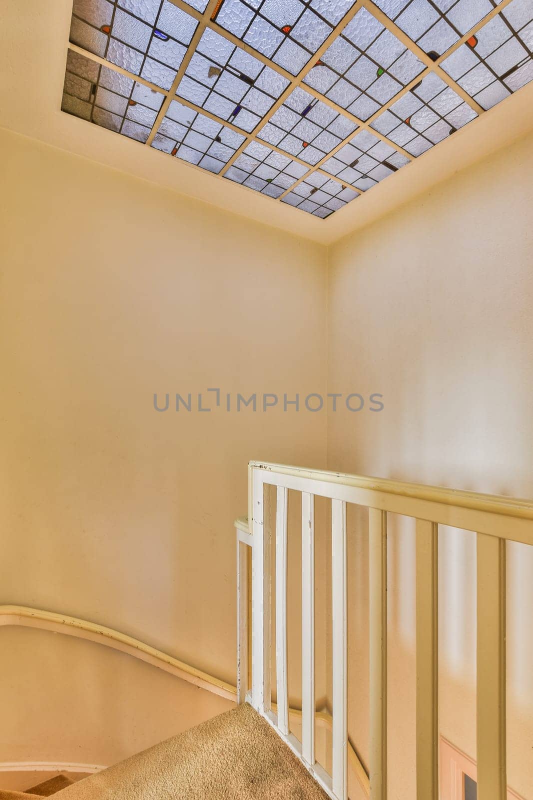 the inside of a room with a skylight above it and stairs leading up to the second floor in an apartment