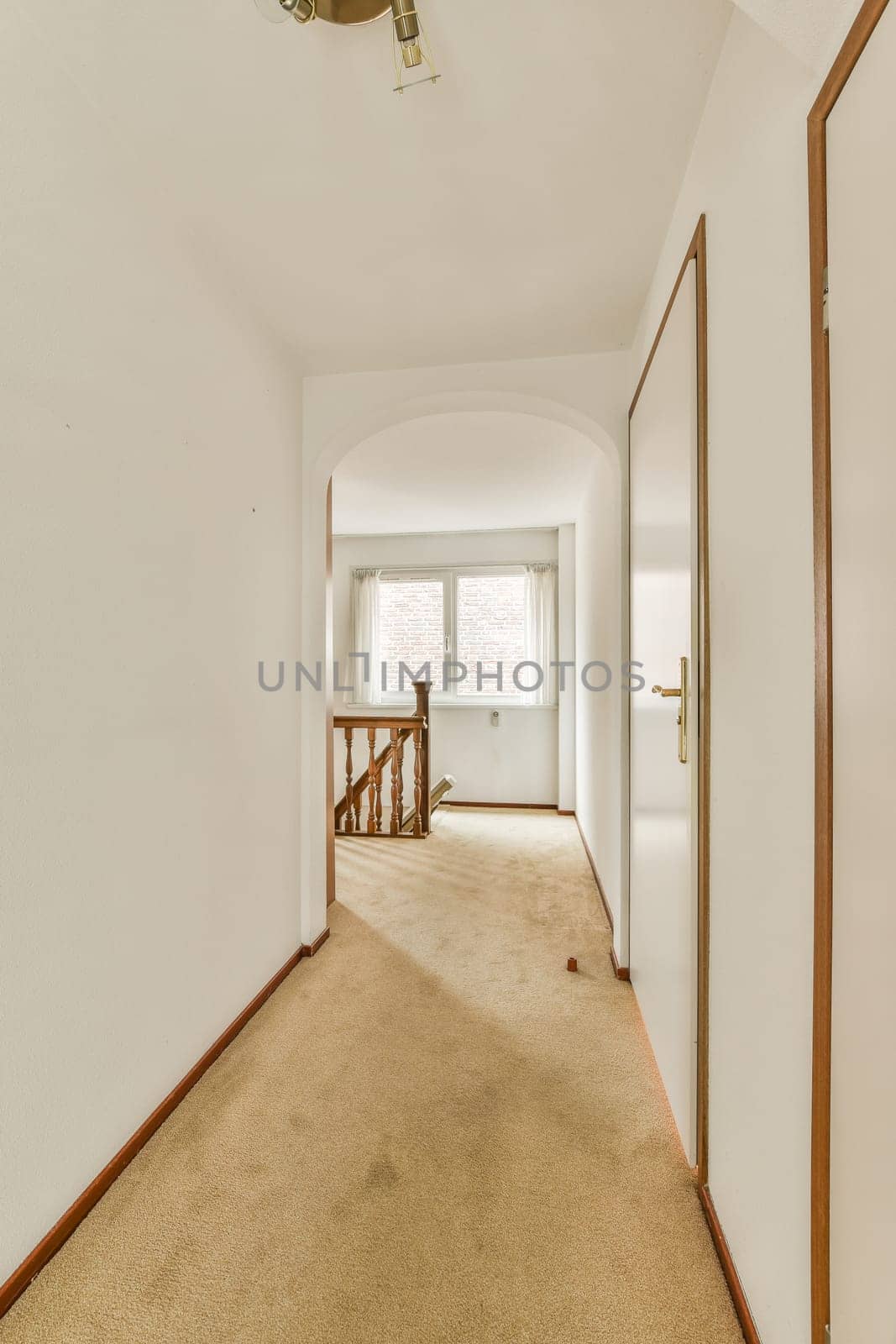 a room with a carpeted hallway and a door by casamedia