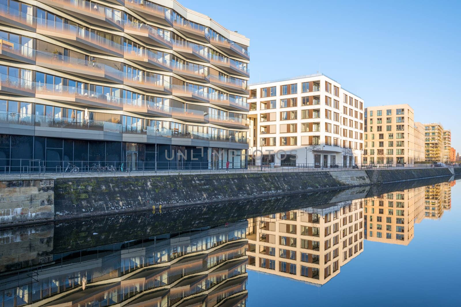 Modern apartment buildings in Berlin with a reflection in a small canal