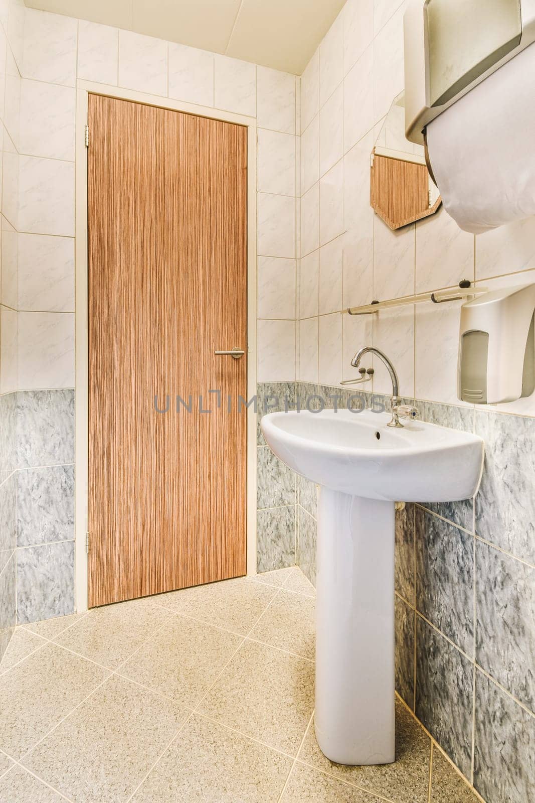 a bathroom with marble flooring and wooden paneled doors on the wall behind it is a white sink in front of a mirror