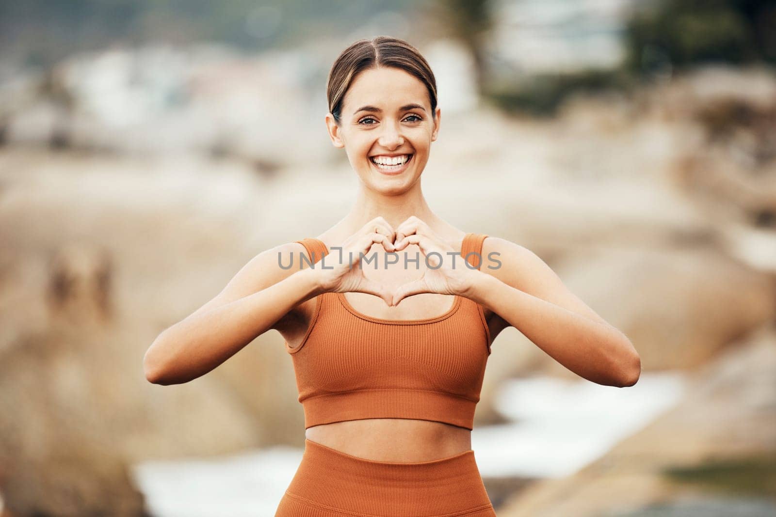 Fitness portrait, hands heart and woman in nature for health or wellness. Sports, training and face of female athlete with emoji for love, affection and romance outdoors getting ready for practice