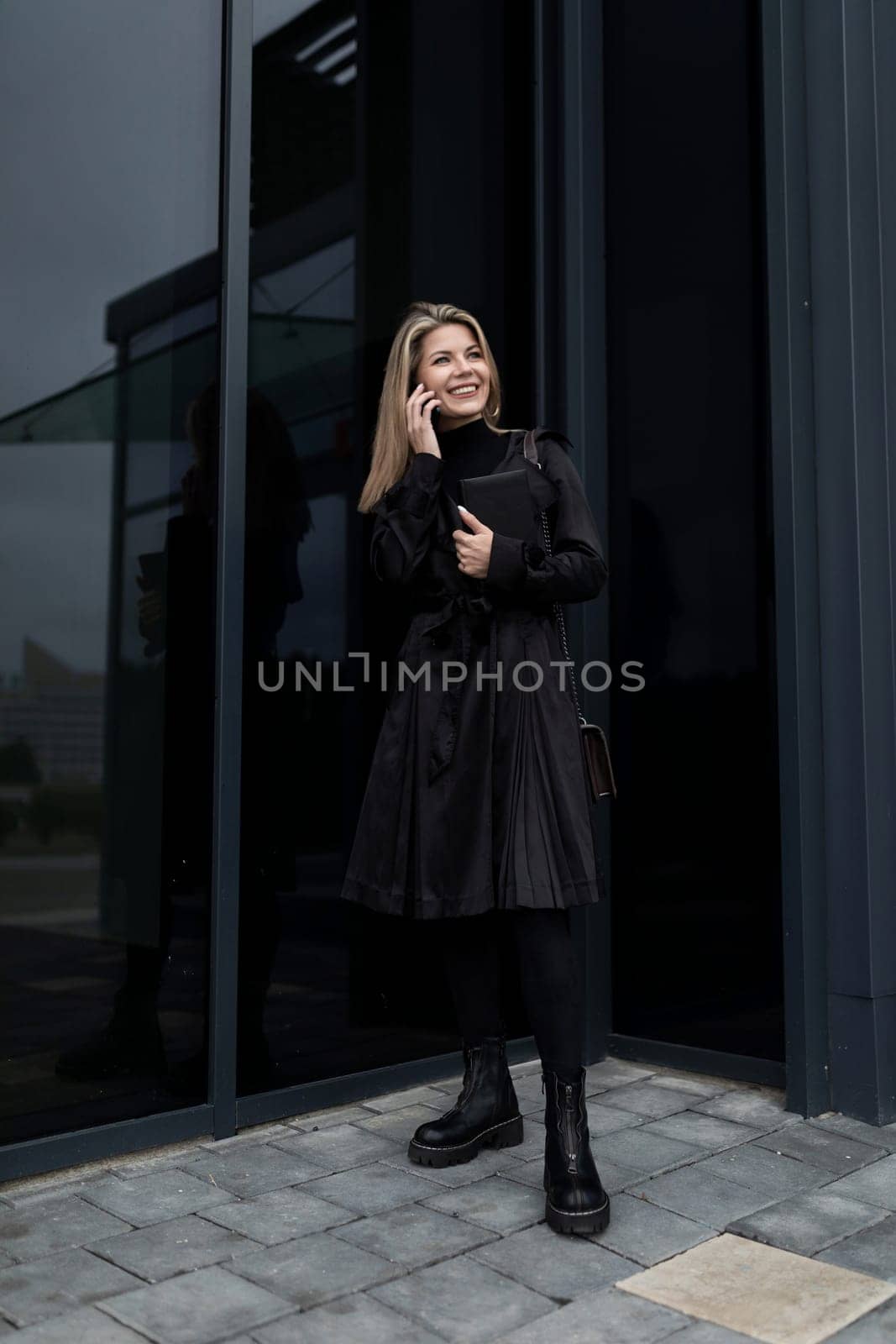 female financial agent stands at the door of the business center.