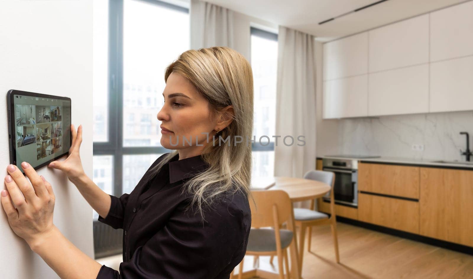 Woman using smartphone monitor to control home connectivity interface by Andelov13