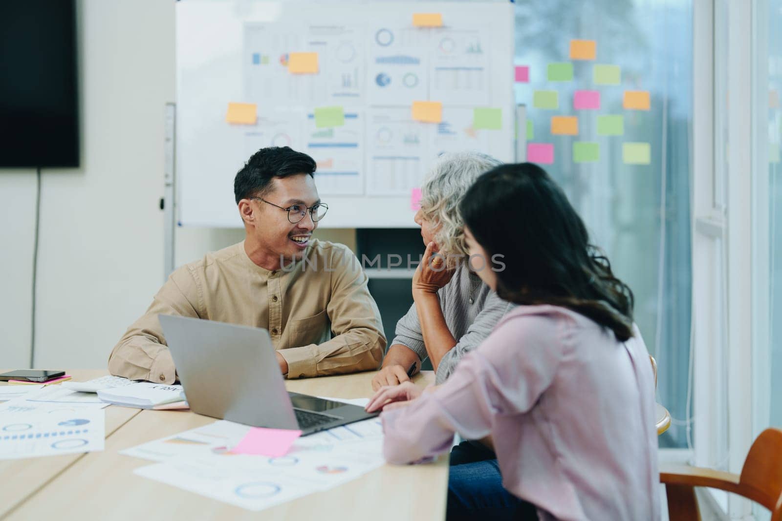 Asian entrepreneurs and business people meeting in a conference room in business planning, financial budget and investment risk assessment to analyze customer groups to increase company growth by Manastrong