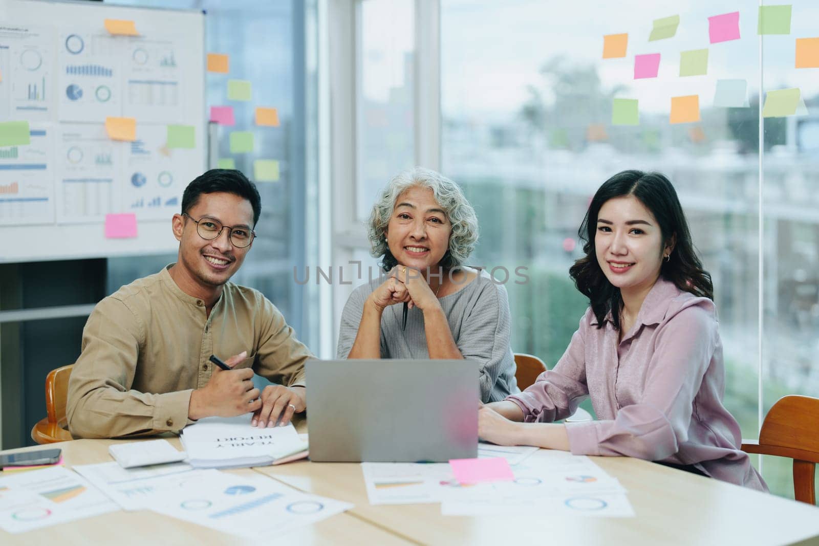 Asian entrepreneurs and business people meeting in a conference room in business planning, financial budget and investment risk assessment to analyze customer groups to increase company growth by Manastrong