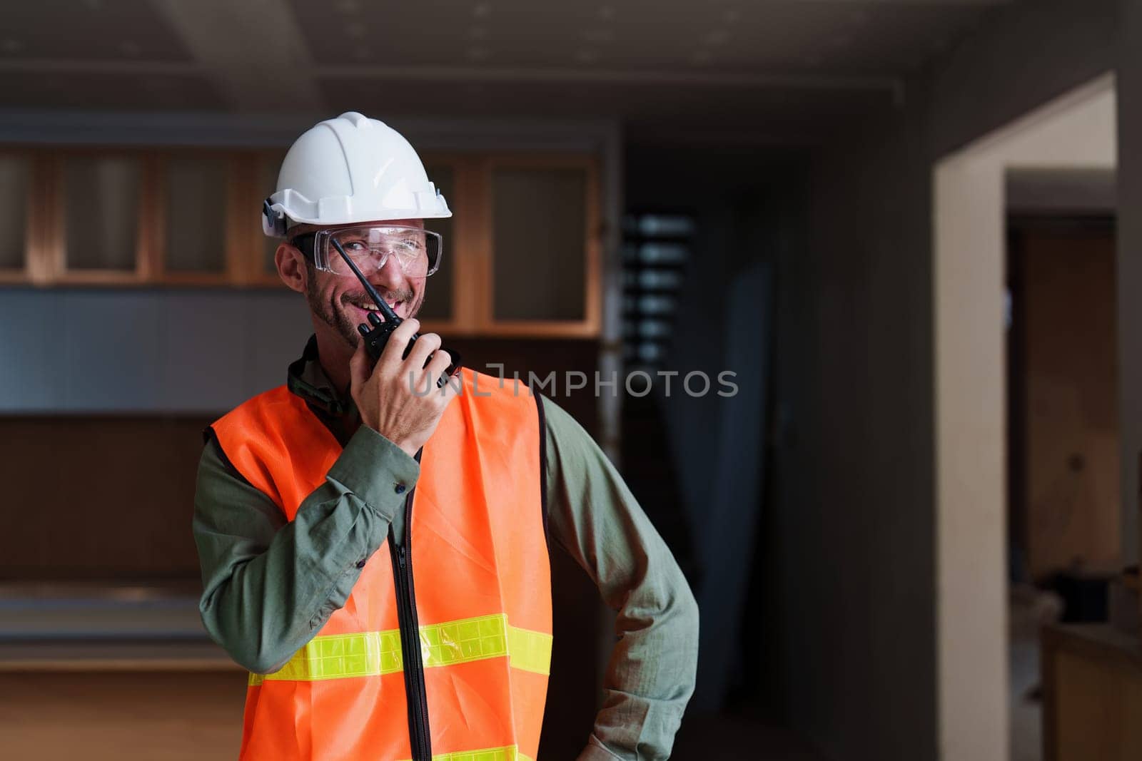 Foreman builder man at construction site. American foreman construction standing at construction site.