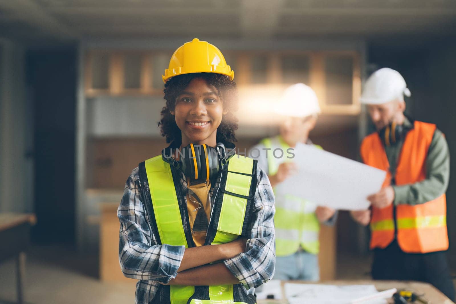 Foreman builder woman at construction site. American African foreman construction standing at construction site.