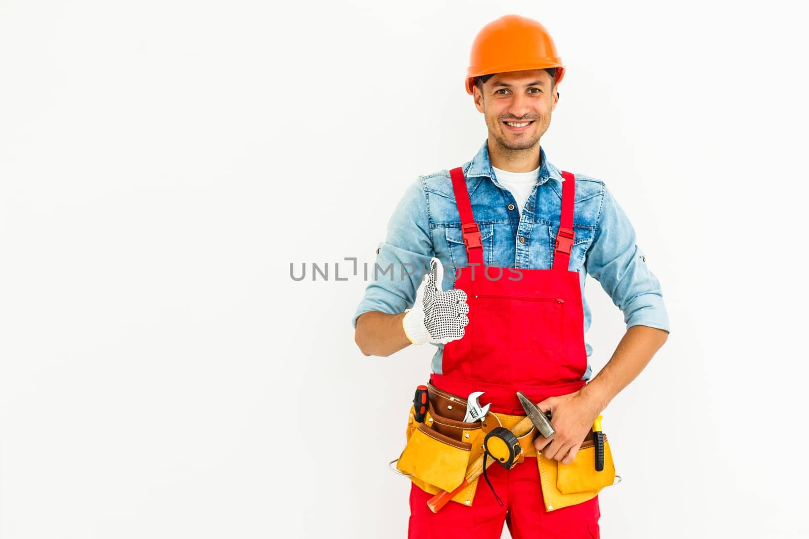 Young construction workers with hard hats on a white background by Andelov13
