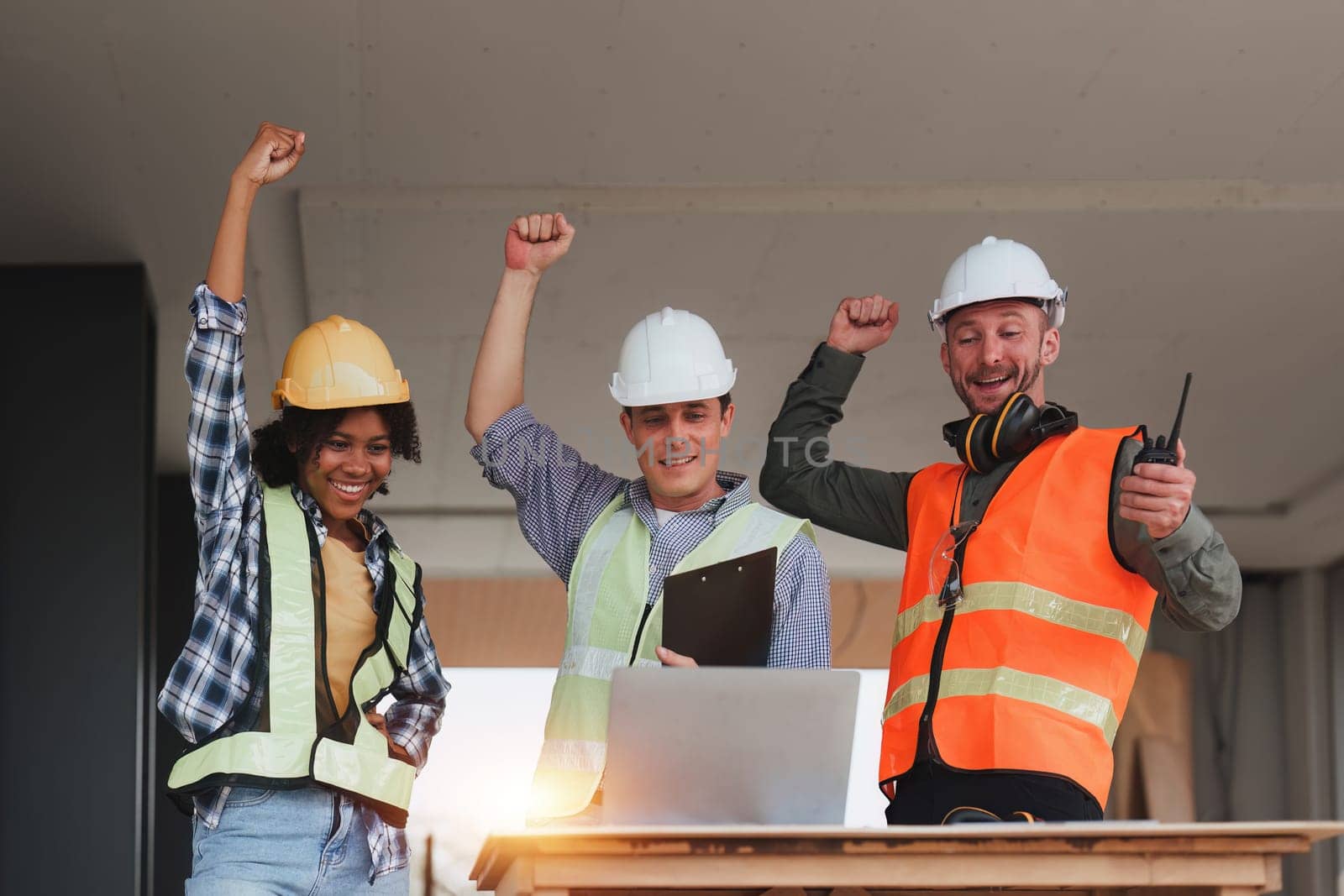 Engineer and Architecture and Foreman celebrate success at construction site. Industrial people and manufacturing labor concept.