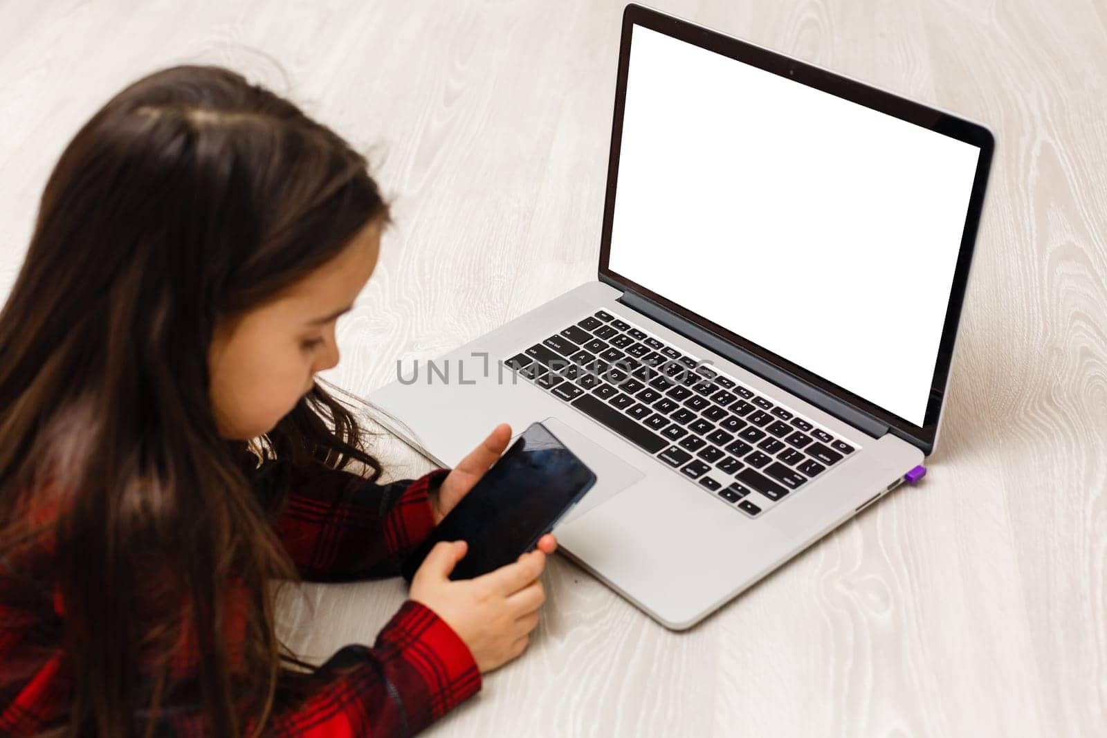 Little girl Hands holding credit card and using laptop.Online shopping in childhood. by Andelov13