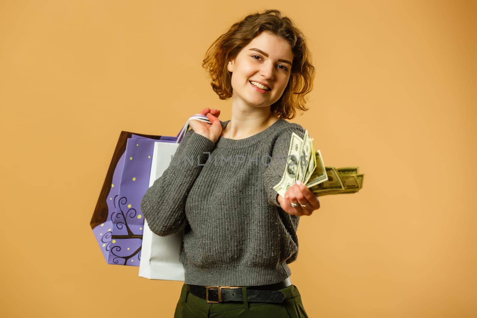 Portrait of happy beautiful shopaholic woman carry shopping bags, advertising concept isolated banner background.