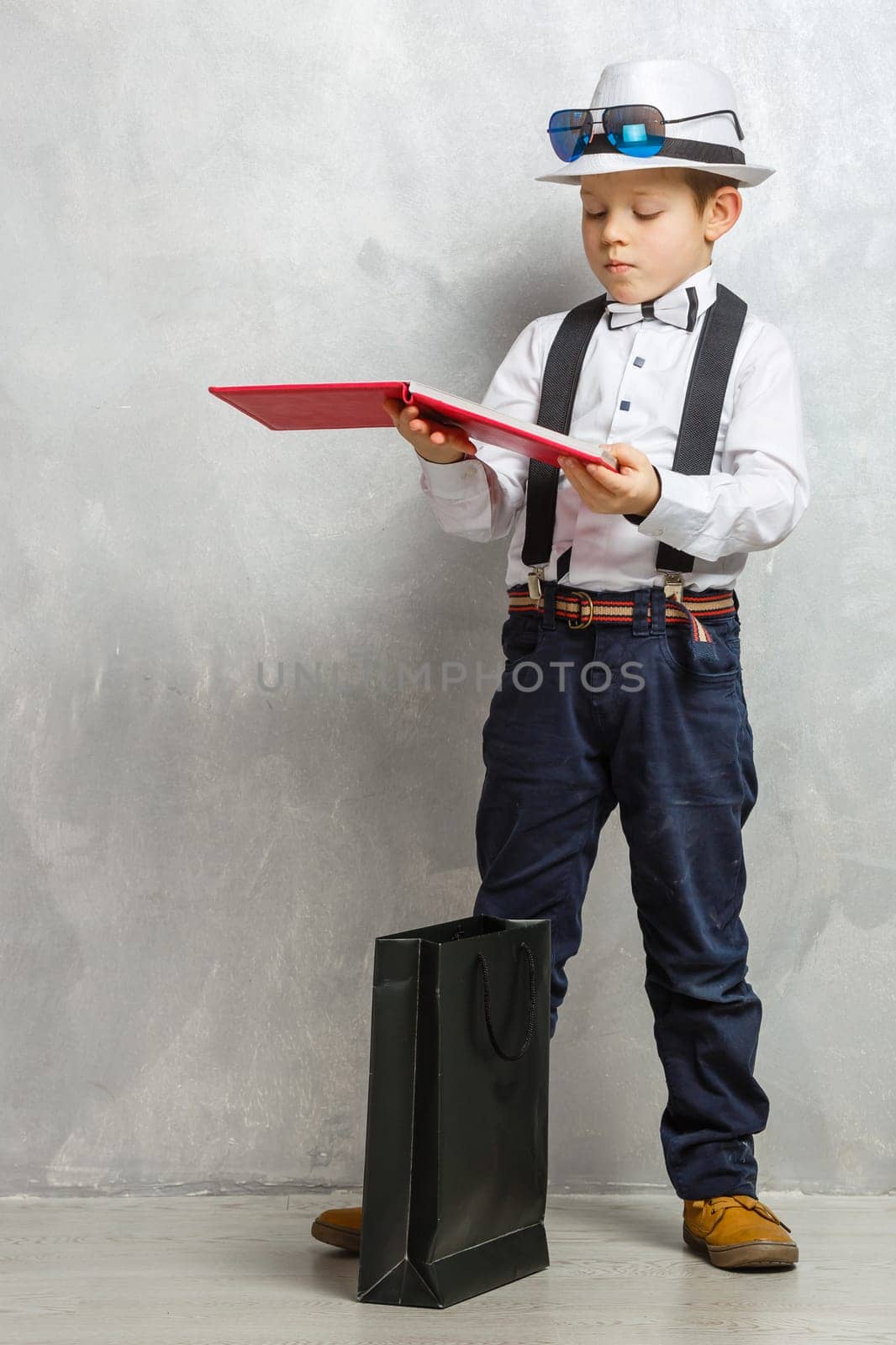 boy holding book on gray background for education concept.
