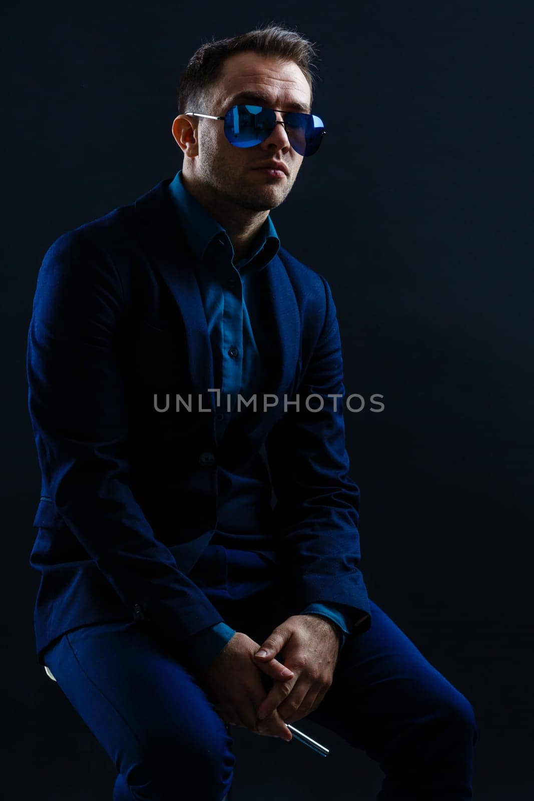 businessmen modern style suit fashion sunglasses dark background. by Andelov13