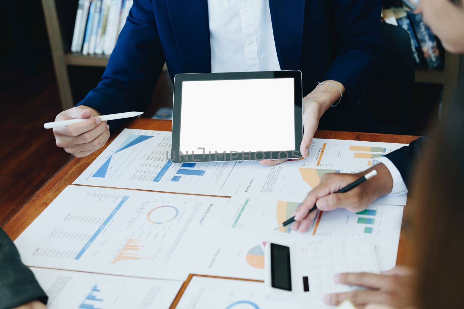 business group people meet and discuss to plan a marketing strategy and come to a conclusion on how to use the financial budget to avoid investment risks holding tablet computer blank screen.