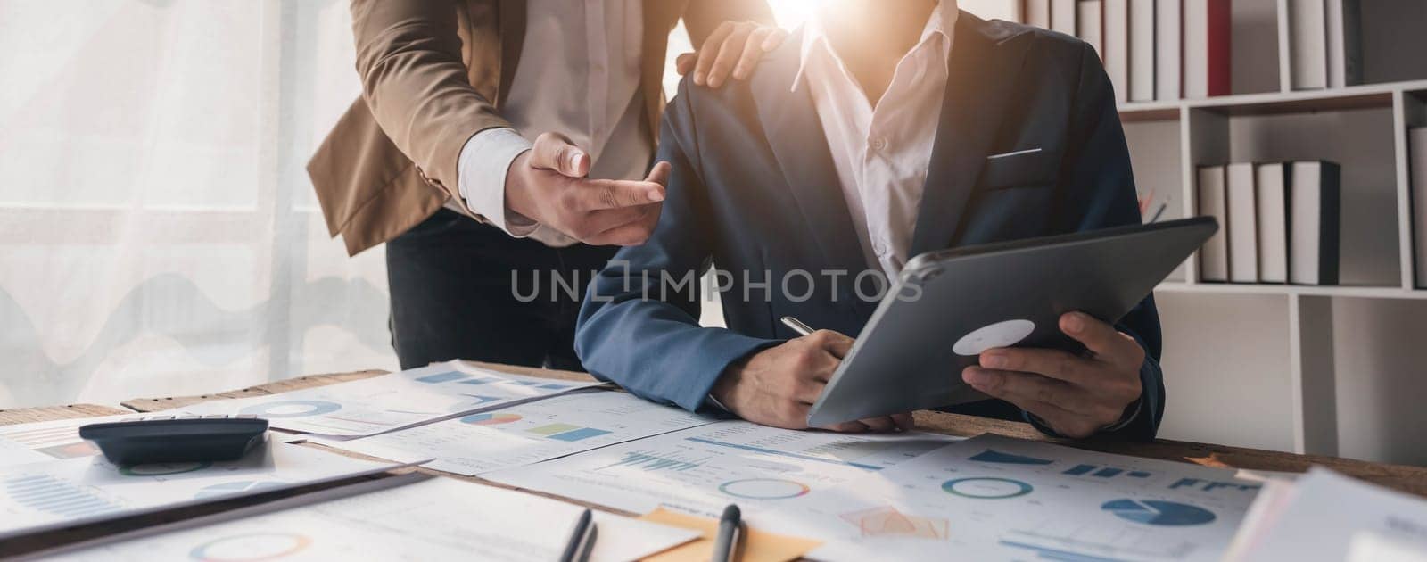 Business People Meeting using laptop computer,calculator,notebook,stock market chart paper for analysis Plans to improve quality next month. Conference Discussion Corporate Concept....