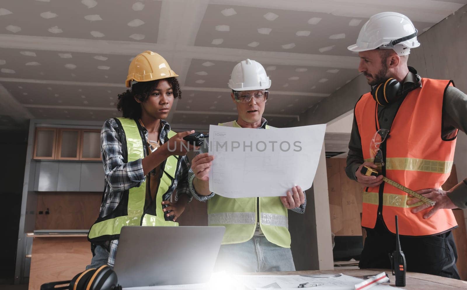 Civil engineer teams meeting working together wear worker helmets hardhat on construction site in modern city. Foreman industry project manager engineer teamwork. Asian industry professional team. by wichayada