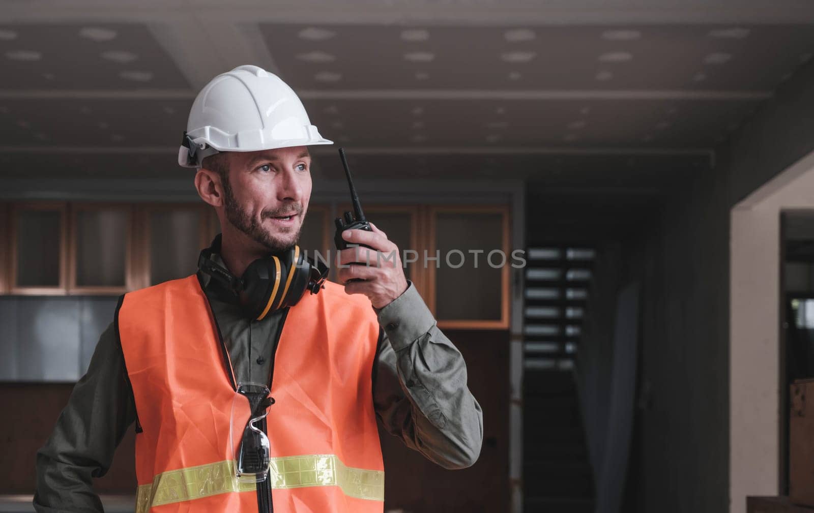 Leadership Concept by male Engineers : Portrait of a happy male engineer in front of a group of male construction workers : Effective teamwork..