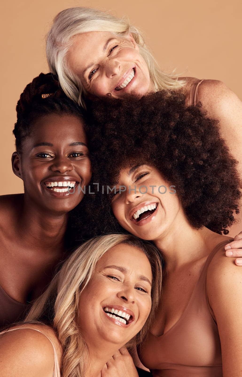 Diversity, beauty and natural with woman friends in studio on a beige background to promote skincare. Portrait, face and smile with a happy female and friend group indoors for luxury cosmetics by YuriArcurs