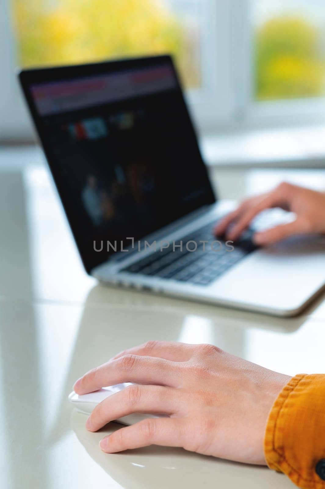 Close up of business woman hand typing on computer keyboard with the mouse while sitting working on the desk in the office or work from home.
