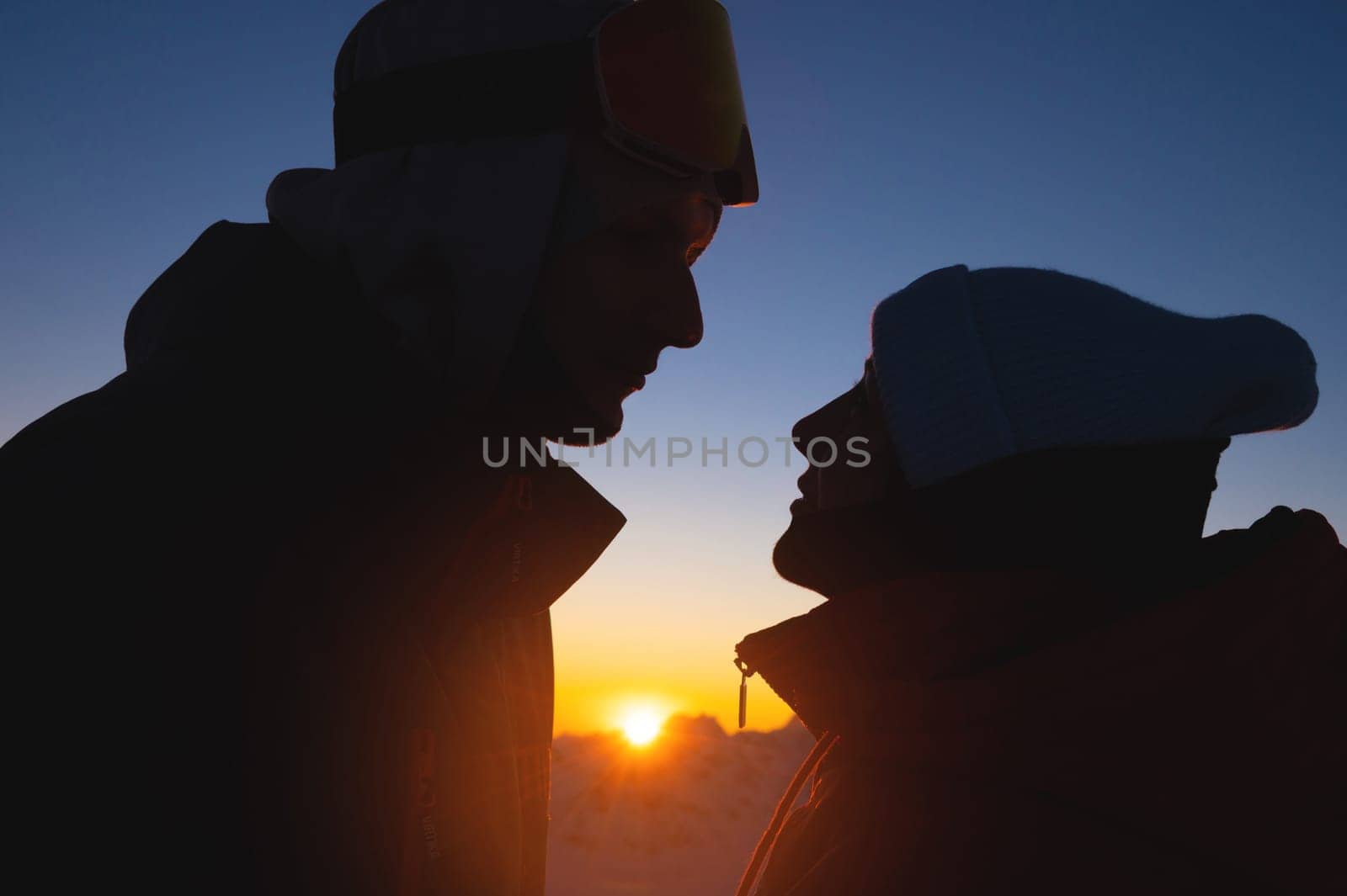 Silhouette of a romantic couple in love outdoors in the mountains at sunset, portrait. happy relationship by yanik88