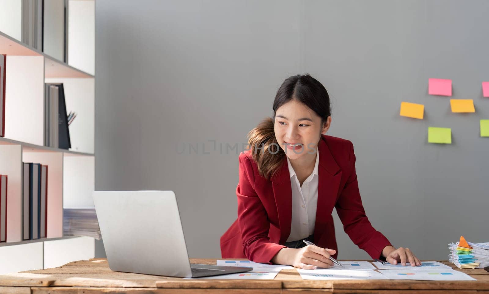 Female businesswoman accountant or financial expert analyze business report graph and finance chart at corporate office.