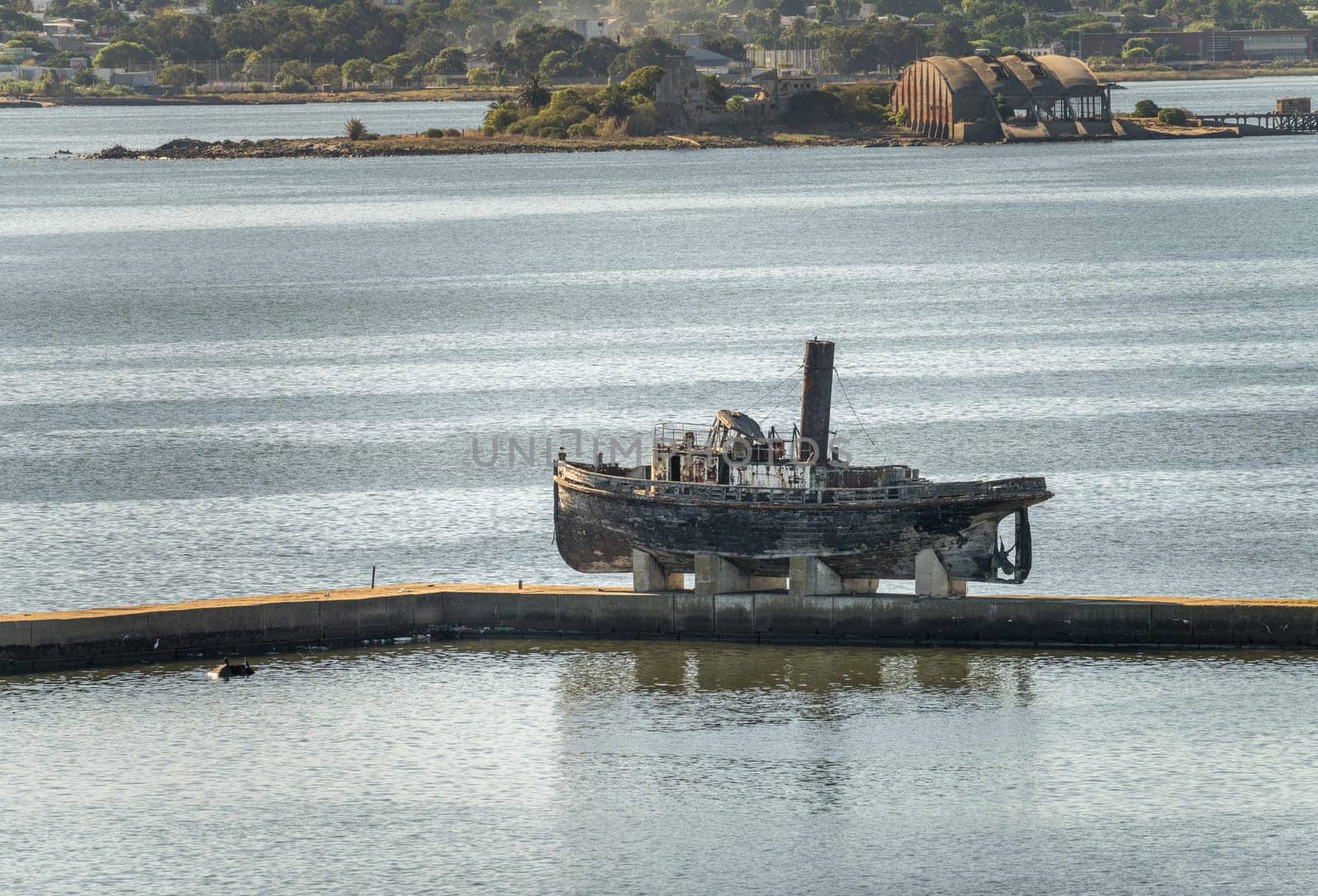 Abandoned wooden steam ship on stands on pier in Montevideo harbor in Uruguay
