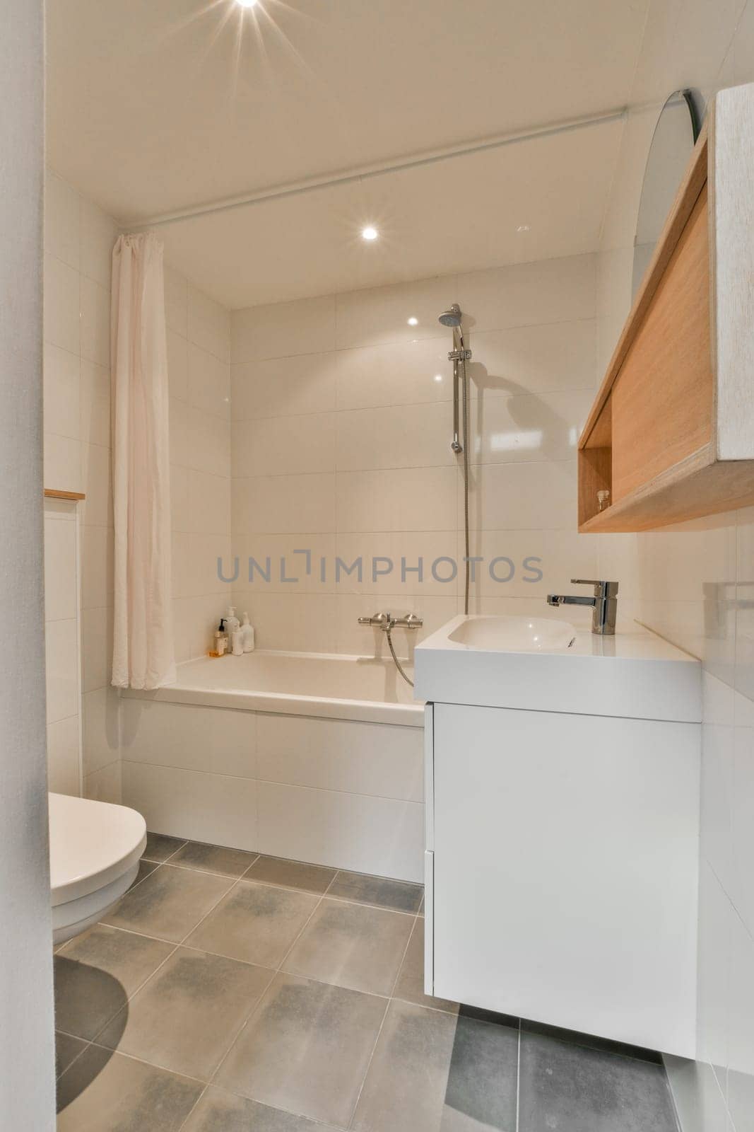 a small bathroom with a sink, toilet and bathtub on the floor next to it is a white tub
