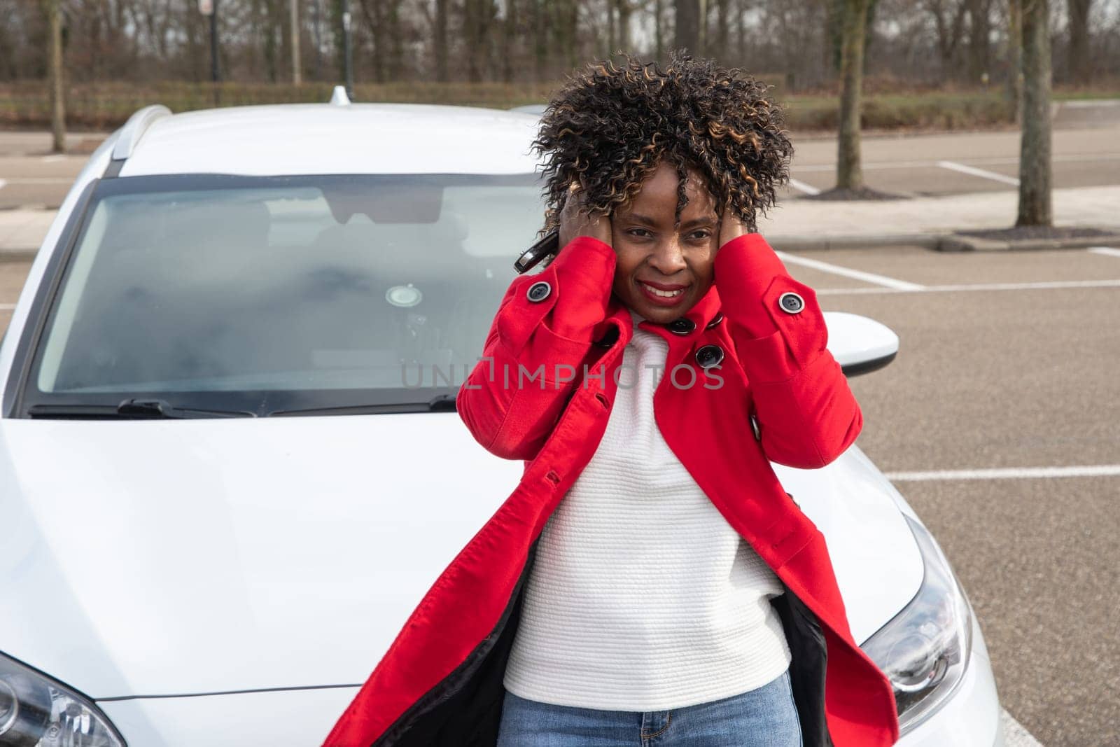 frustrated african american woman holding her hair with her hands due to wind by KaterinaDalemans