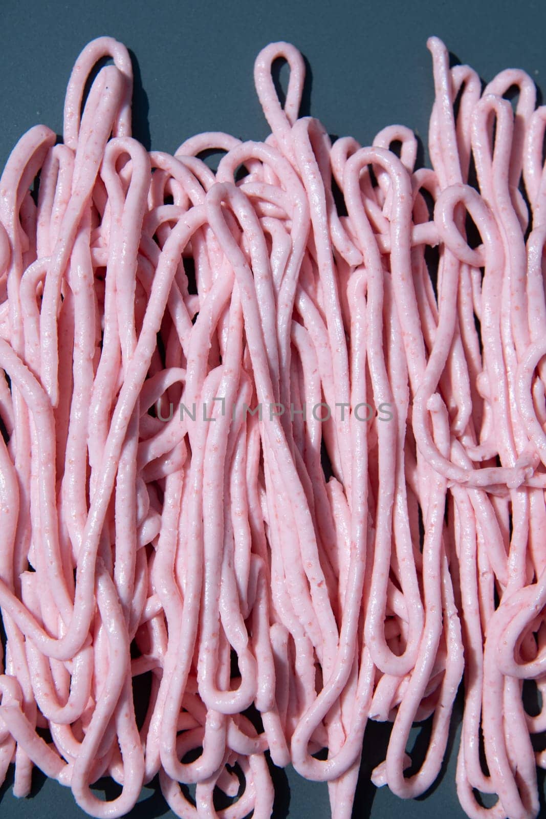 pink tarama pasta on a gray plate squeezed out of a cooking bag,creative texture by KaterinaDalemans