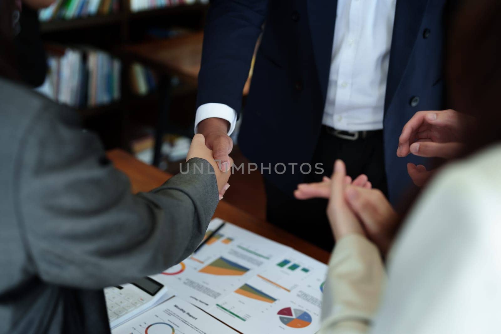 Asian entrepreneurs handshakes to congratulate the agreement between the two companies to enhance investment and financial strength. deal concept.