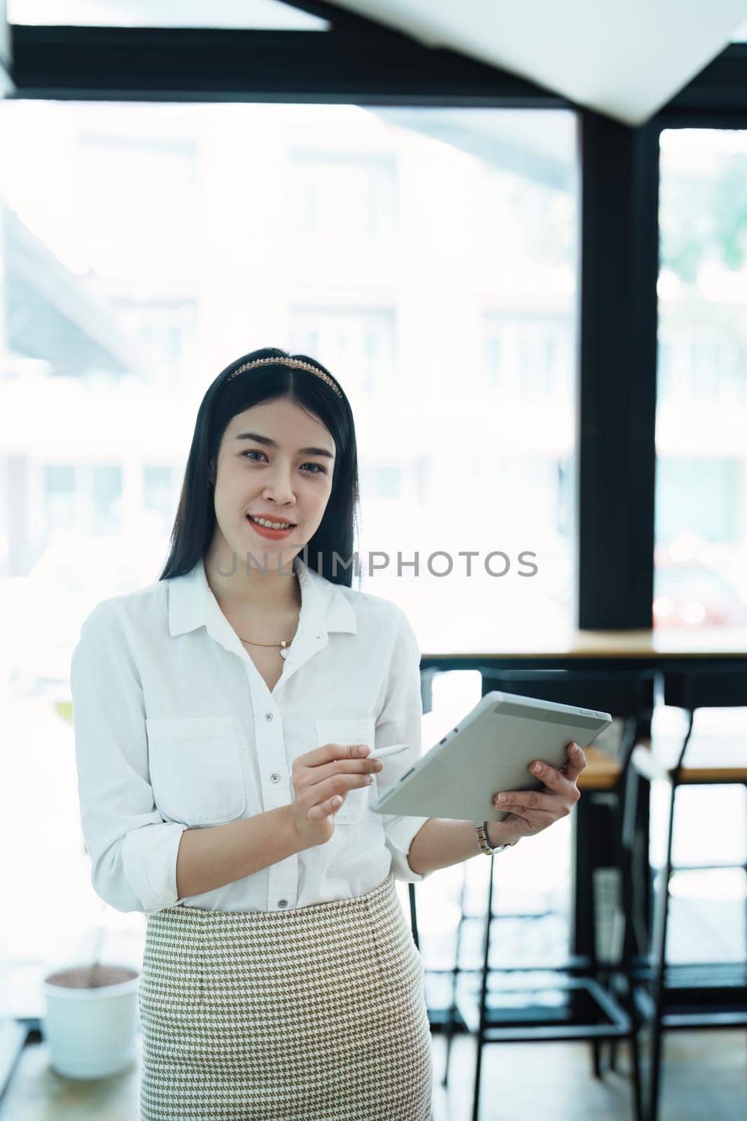 Portrait of a beautiful Asian teenage girl using a tablet computer.