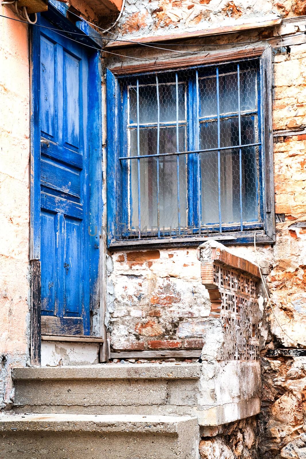 Door and window painted blue on facade of old village house, vertical frame by Laguna781