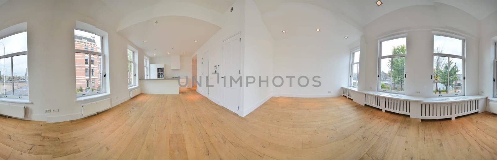 a large white room with large windows and wood floors by casamedia